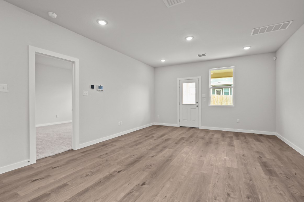 A room with a wood floor and a wood floor.