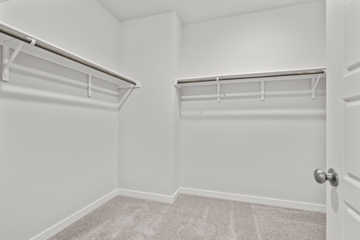 A white door with a metal bar.