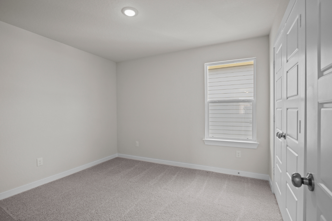 A room with white walls and a white door.