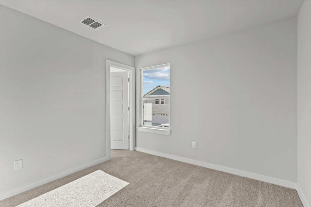 A room with a door and a rug.