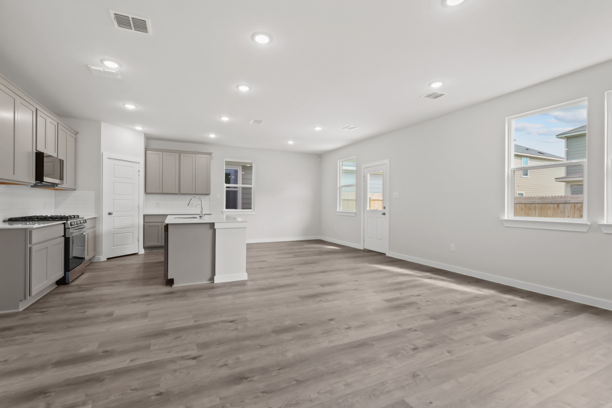 A kitchen with white cabinets.