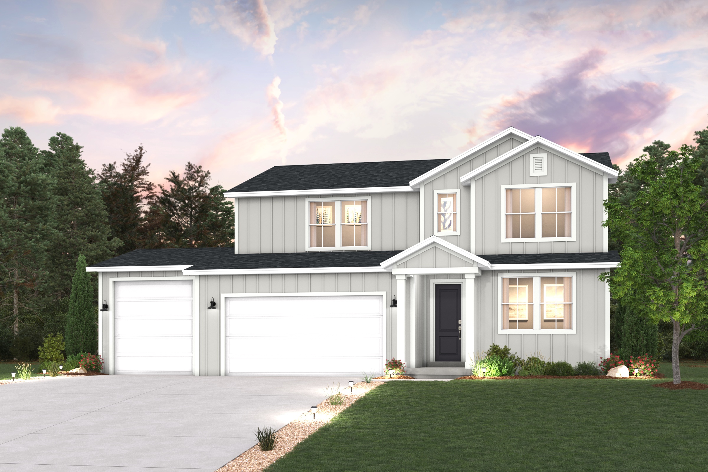 A house with garages and a lawn in front of it.