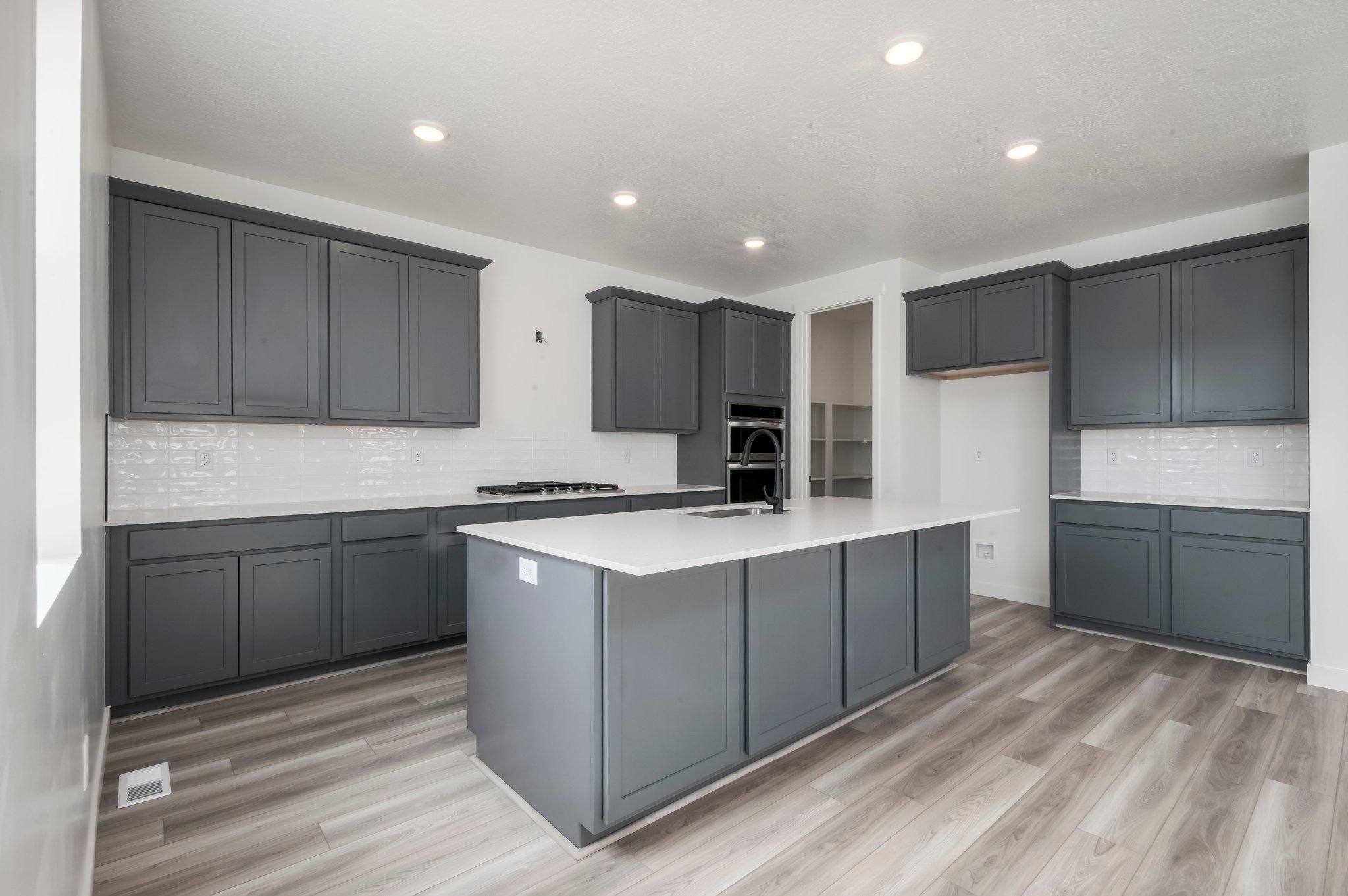 A kitchen with black cabinets.