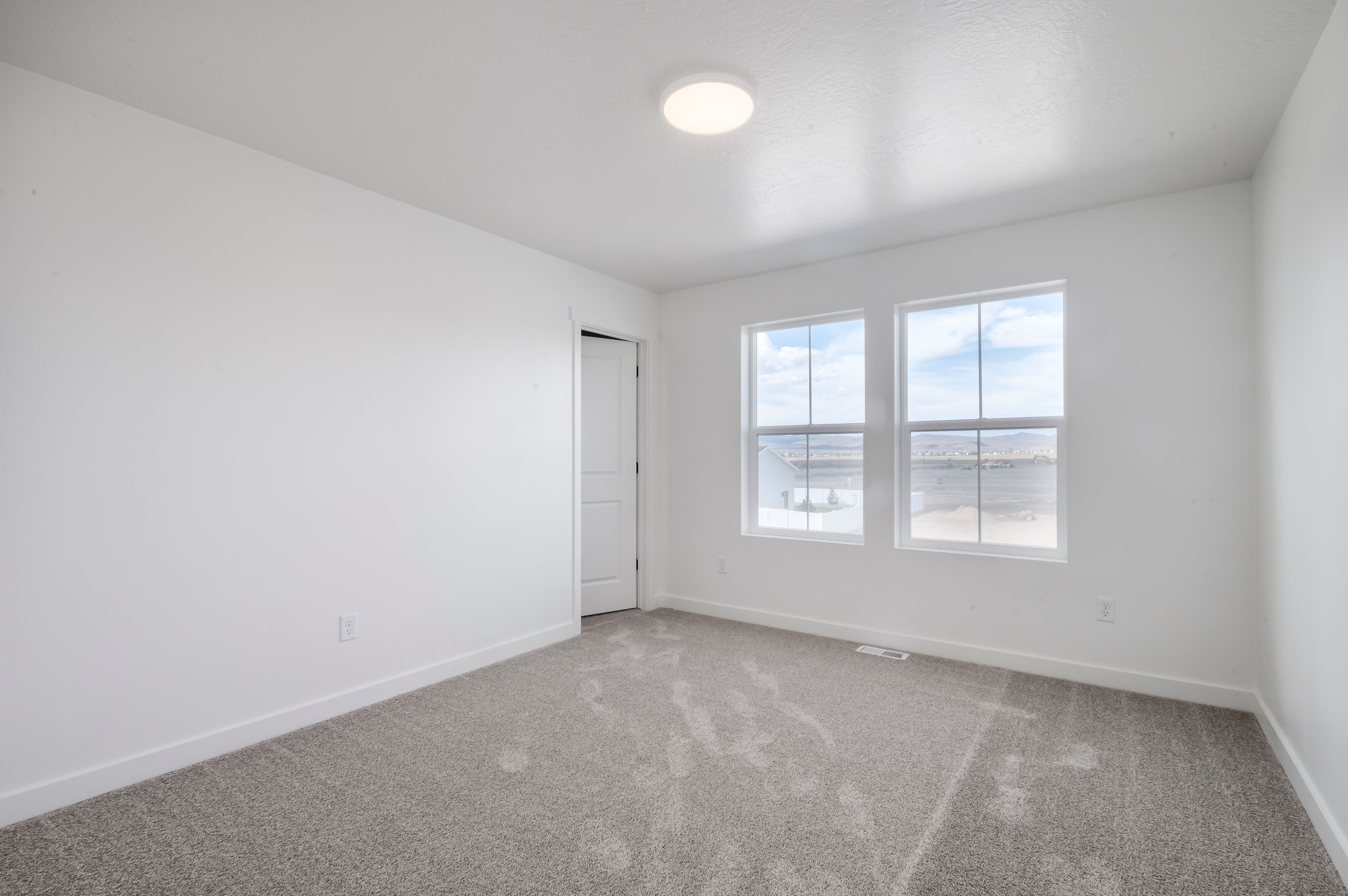 A room with a door and windows.
