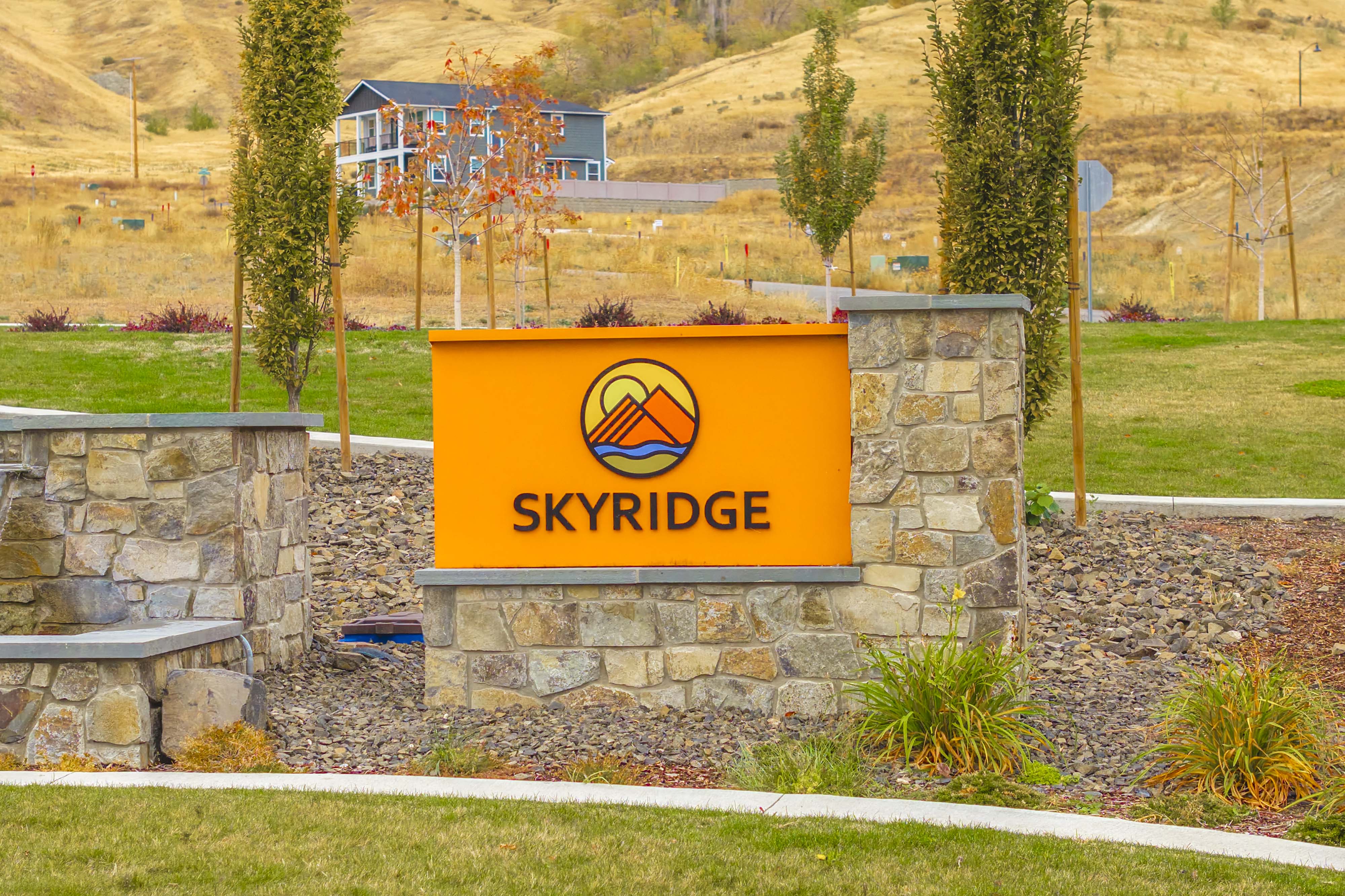 A sign on a stone wall.