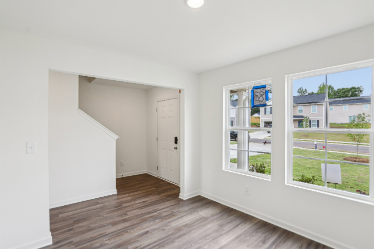 A room with a wood floor and windows.