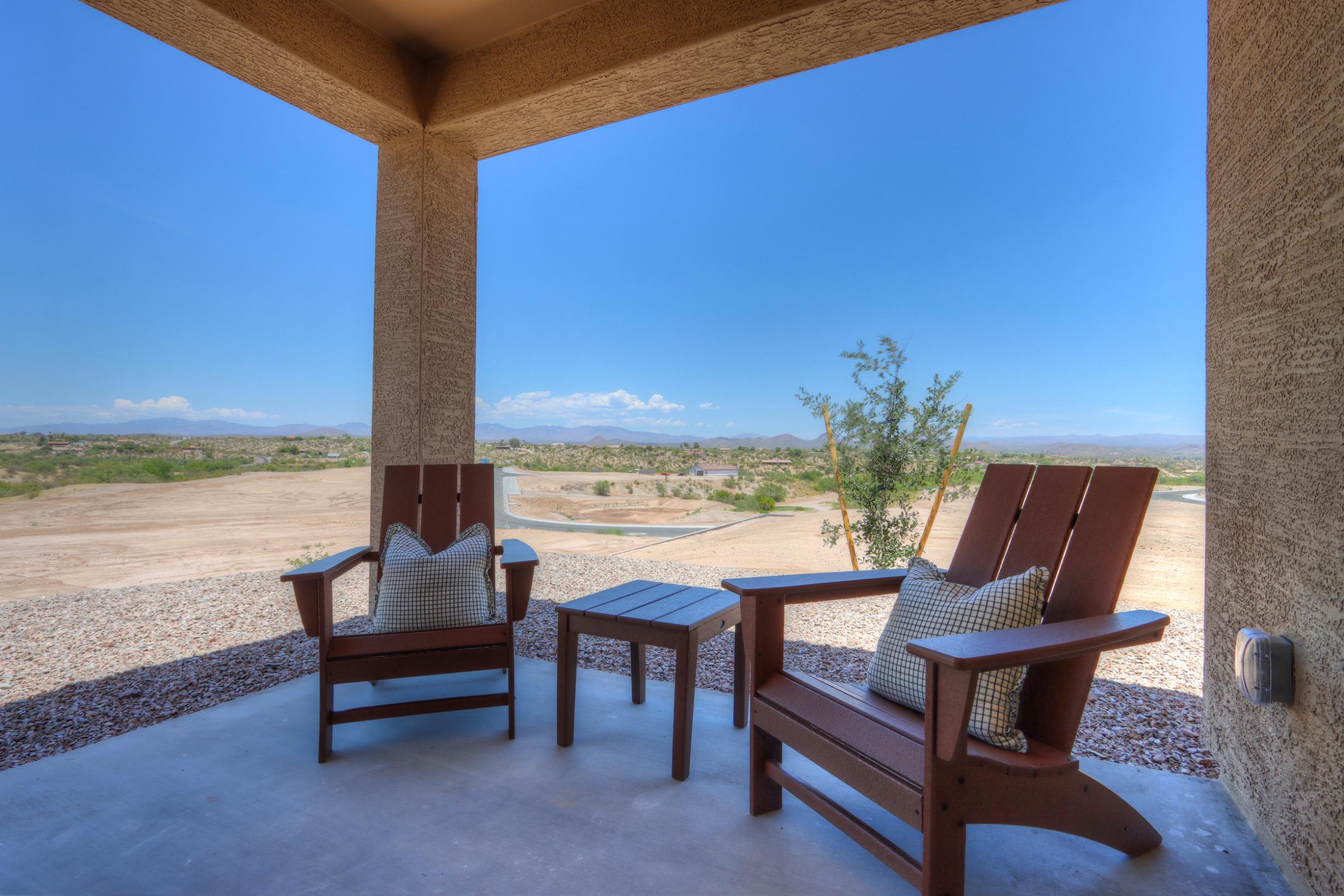 A patio with chairs and a table.