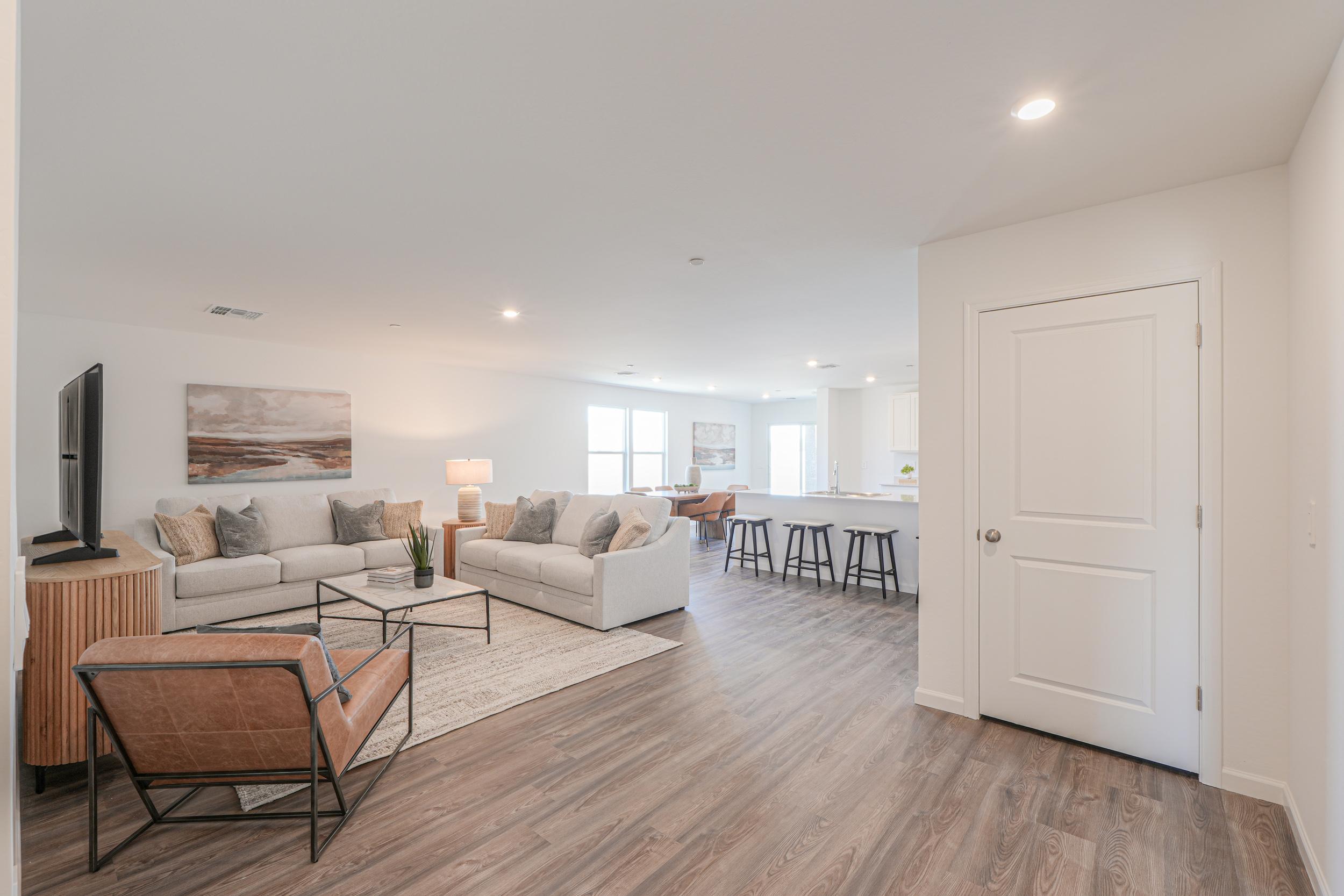 A living room with a wood floor.