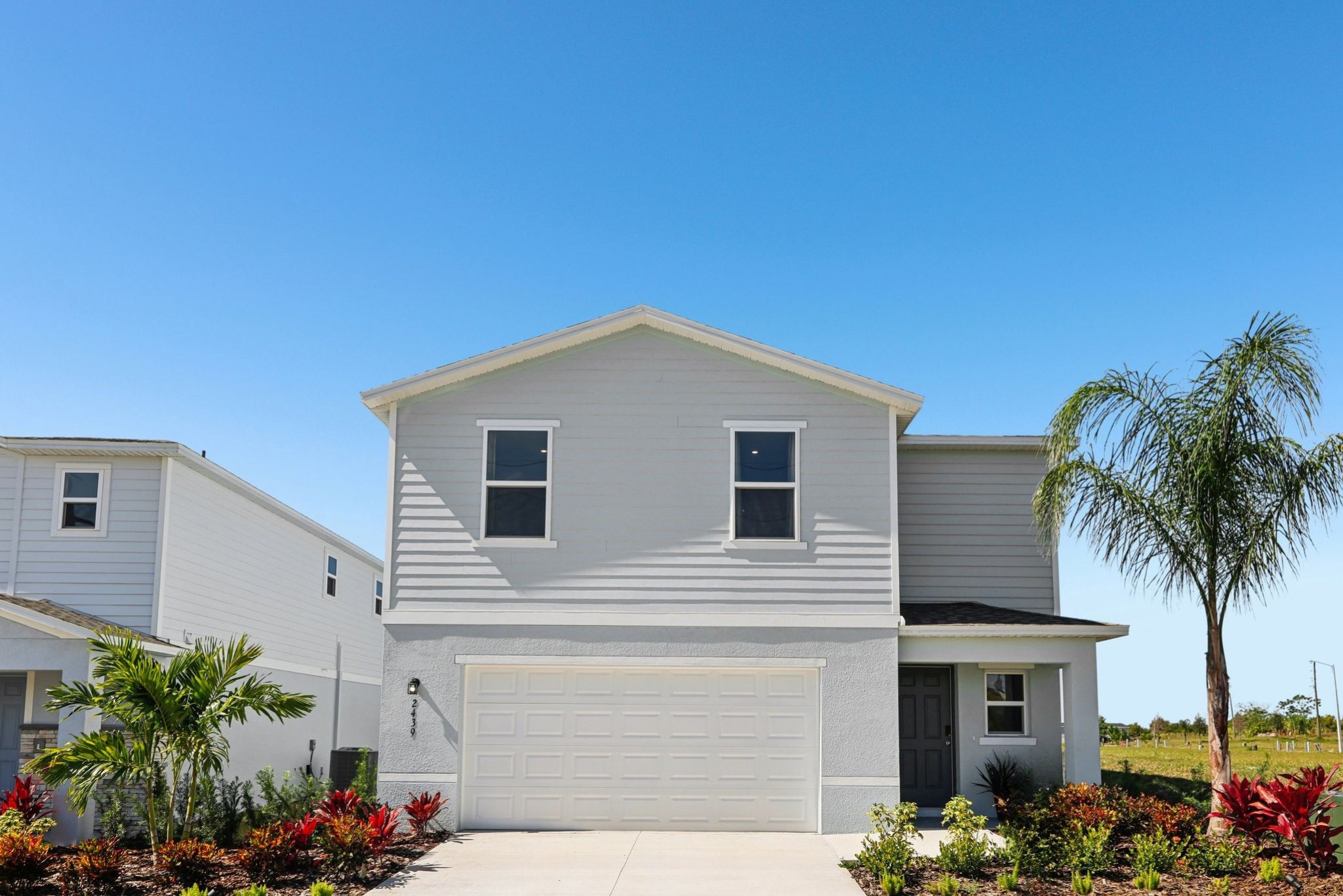 A white house with a garage.