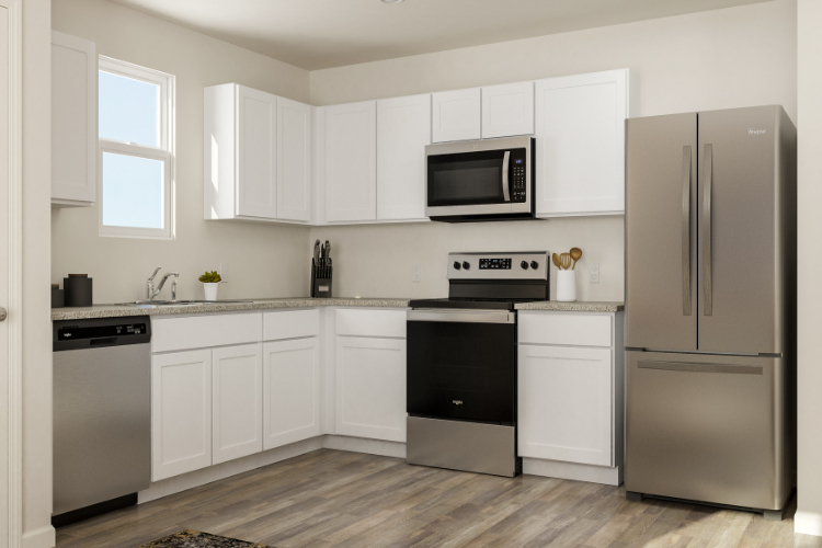 A kitchen with white cabinets.