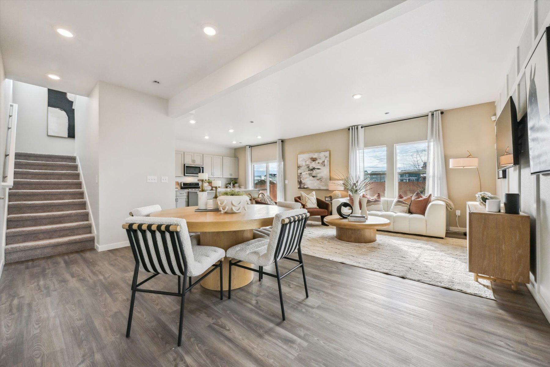 A large living room with a dining table and chairs.